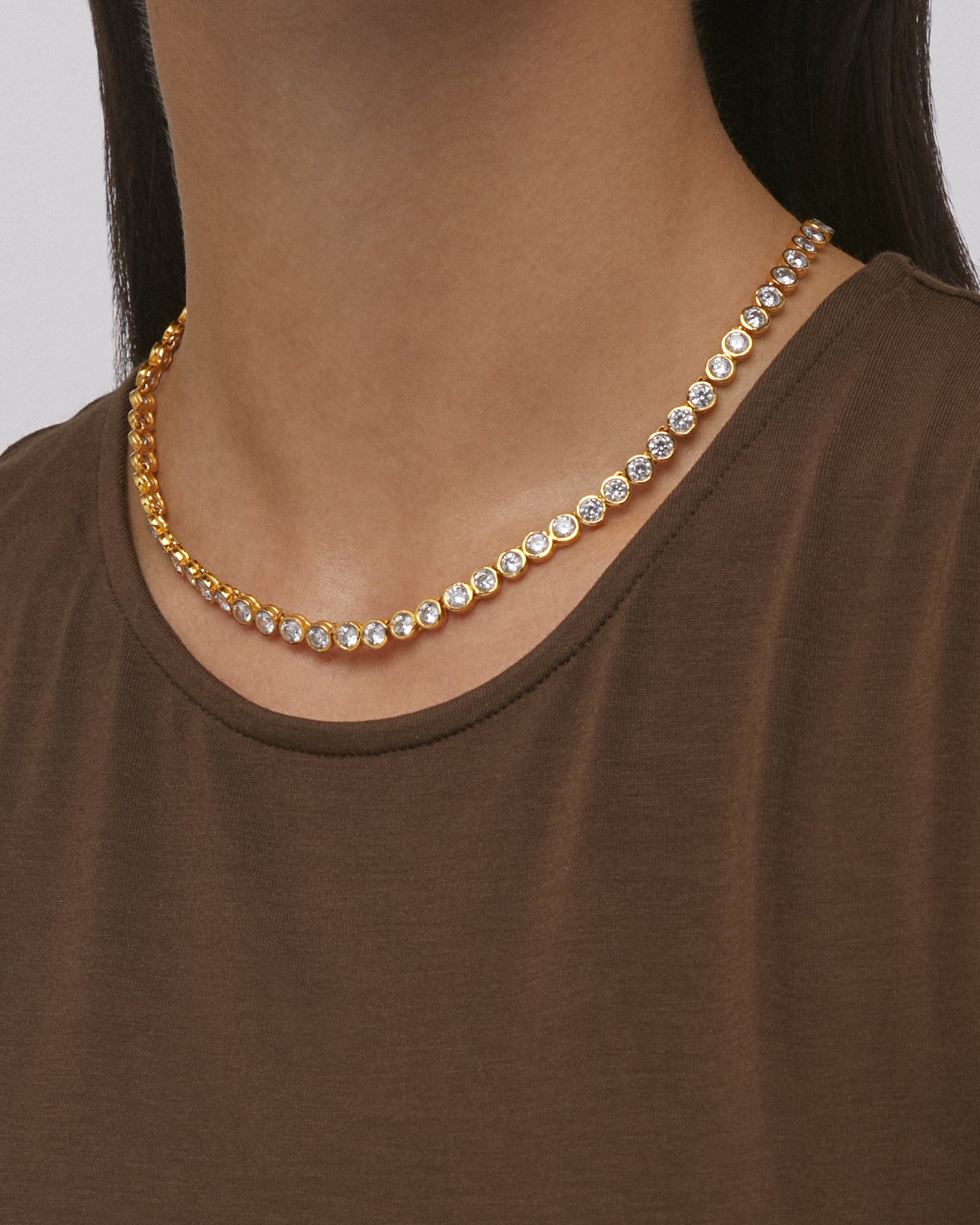 Daphine Chris gold tennis necklace with cubic zirconia.