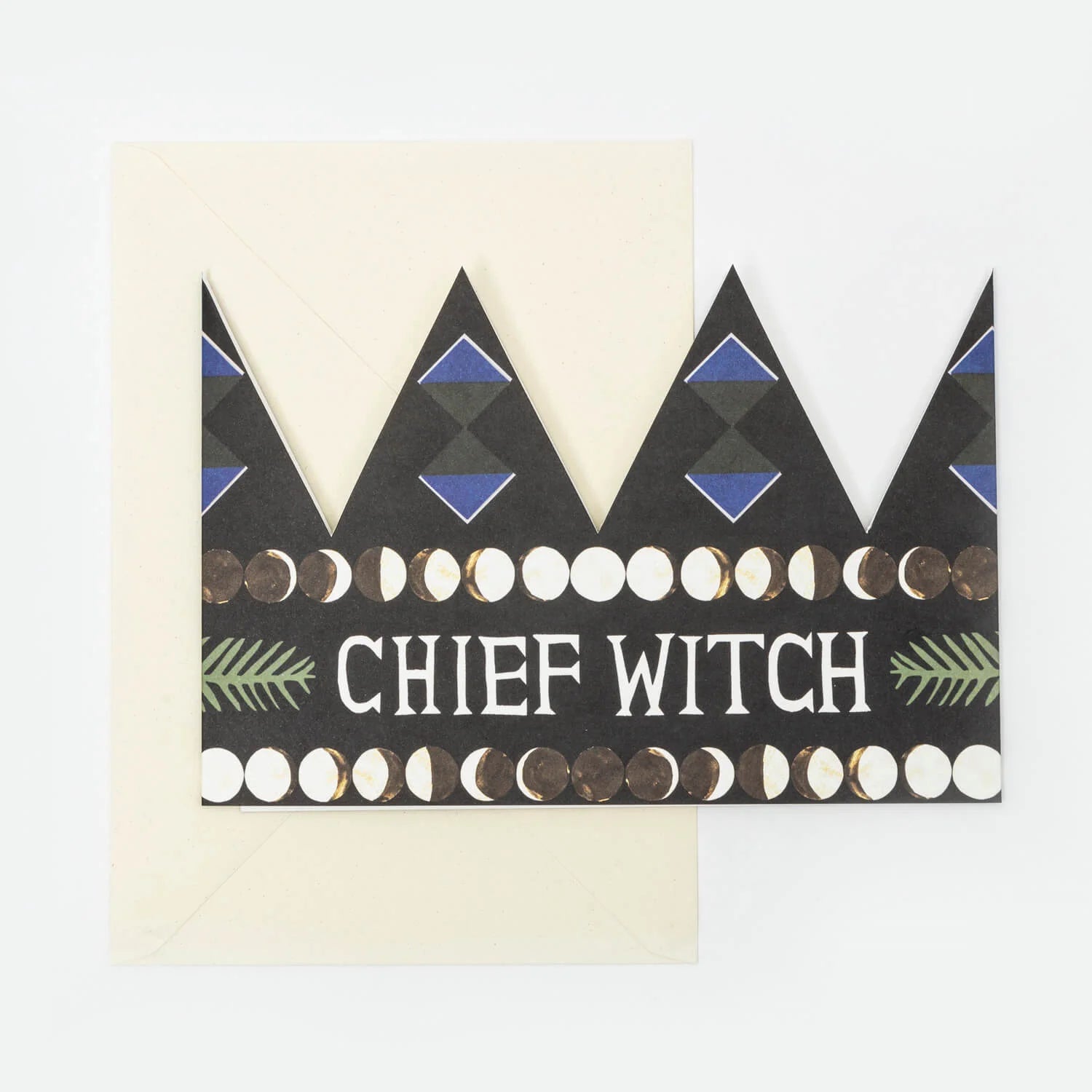 Hadley Paper Goods Chief Witch party hat crown shaped card in black with blue, green and white pattern, and ivory envelope, on a white background.