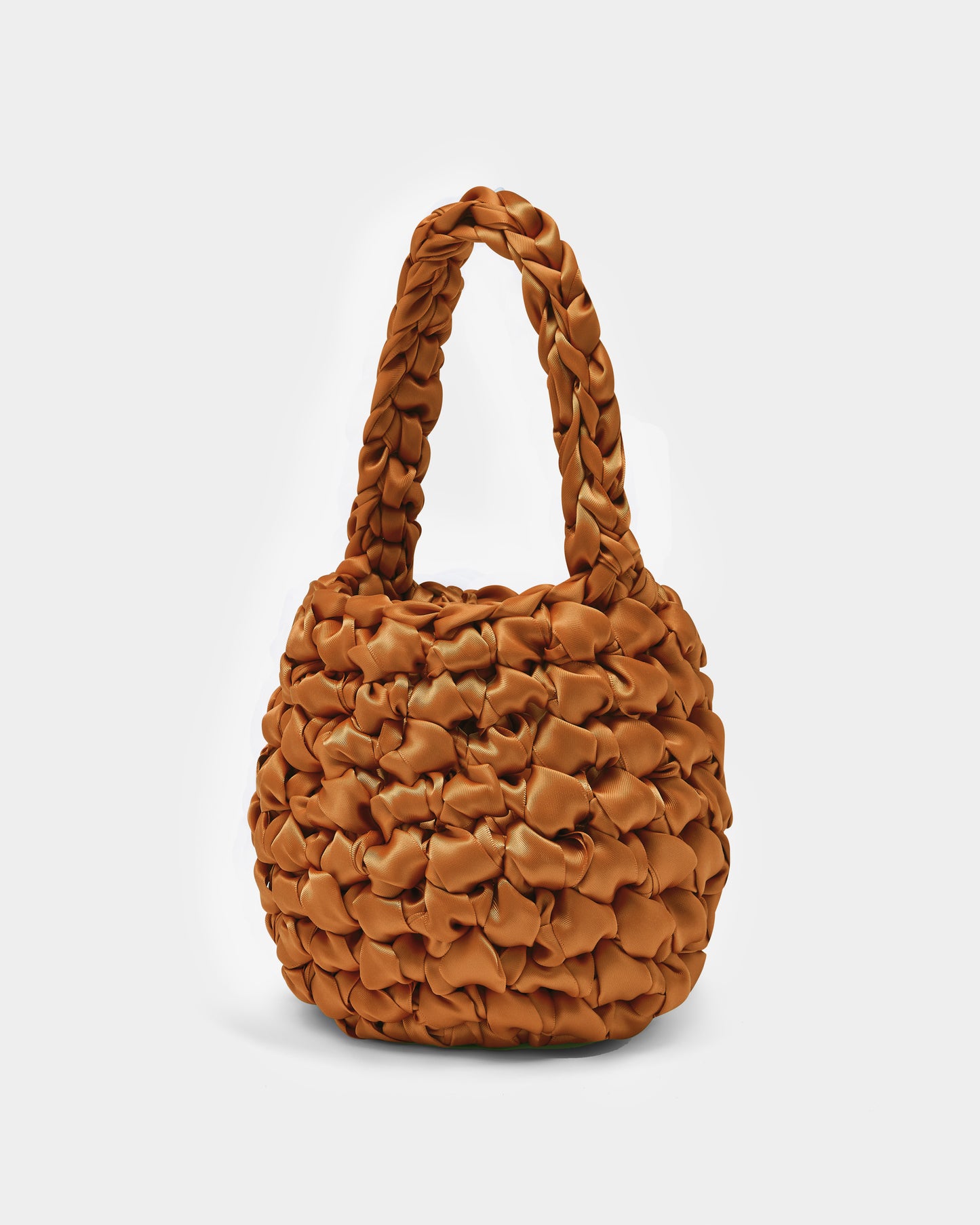 Isla de Gar terracotta orange ribbon crochet bag with handle on a white background.