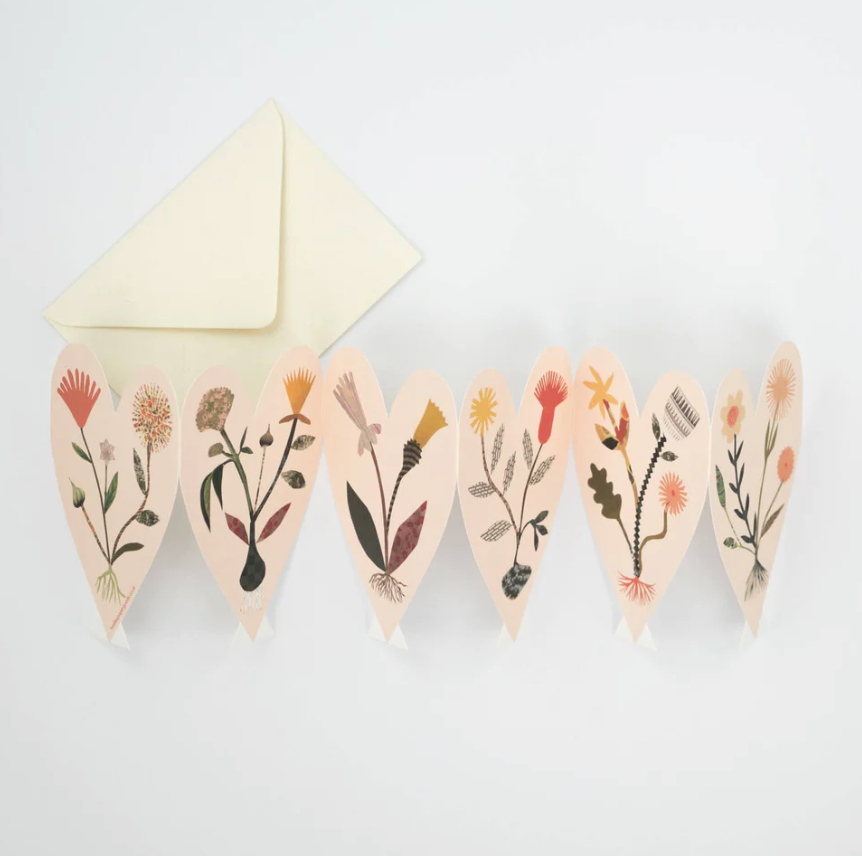 Hadley Paper Goods pale pink heart concertina card of six hearts with wild flowers plus a cream envelope, on a white background.