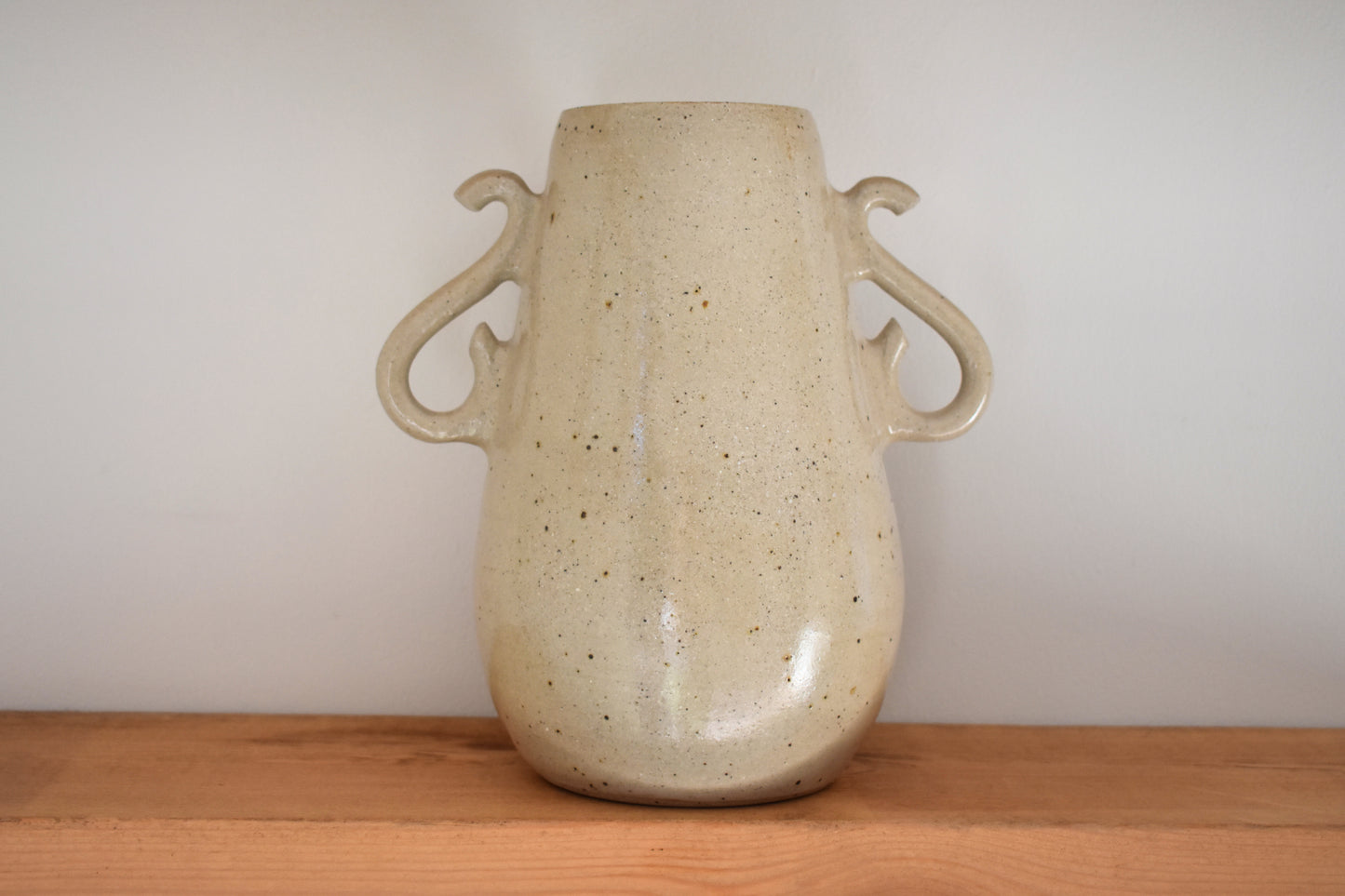 We Are Clay Curly Vase in flecked beige ceramic with curly handles.