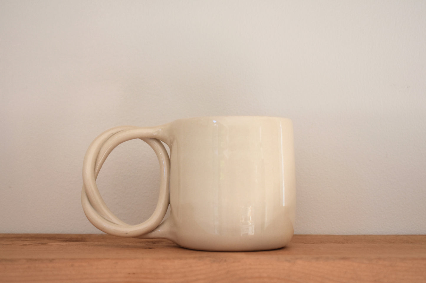 We Are Clay white ceramic Pretzel Mug with twisted pretzel handle.