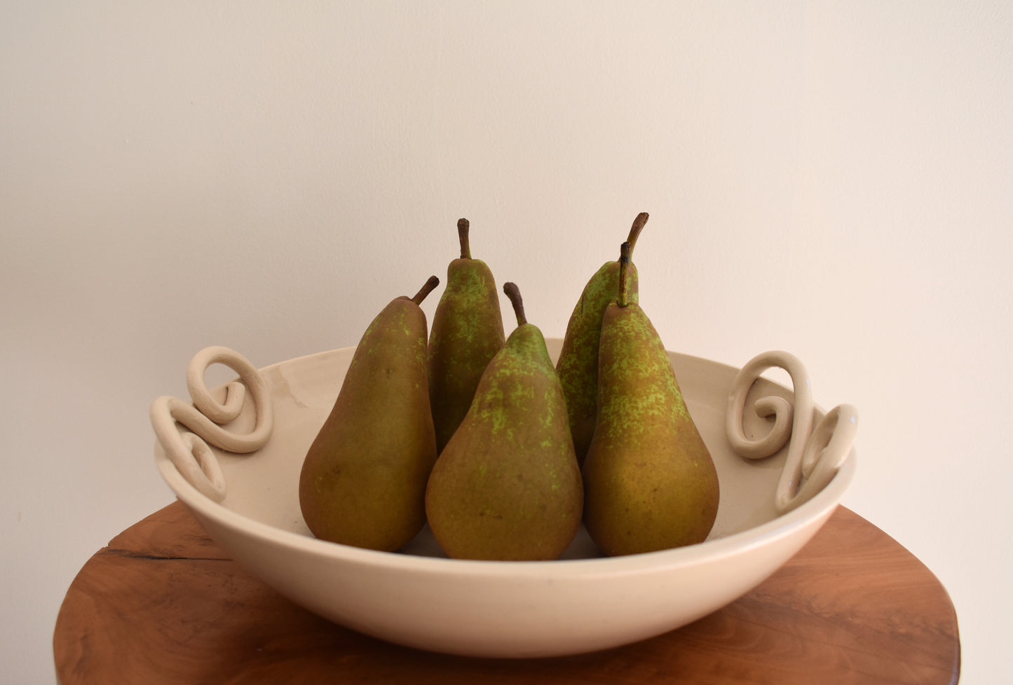 We Are Clay Pretzel fruit bowl in white ceramic with spiral design.