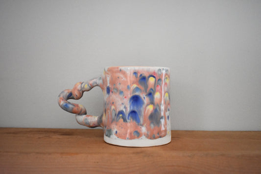 Harlie Brown ceramic earthenware Melted Candy Wiggle Mug with pastel glaze and curly handle.