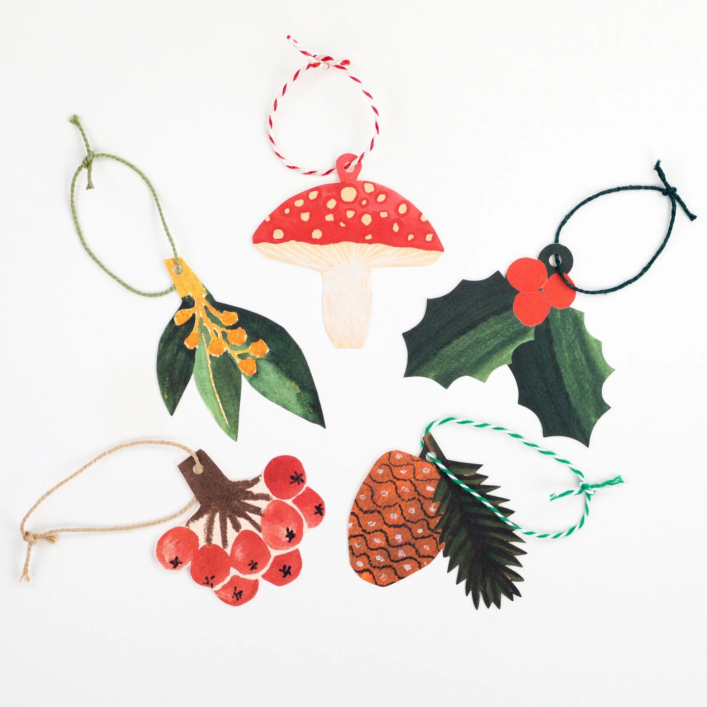 Hadley Paper Goods set of 5 Christmas-themed gift tags including a mushroom, holly, berries, and pine cone on a white background.
